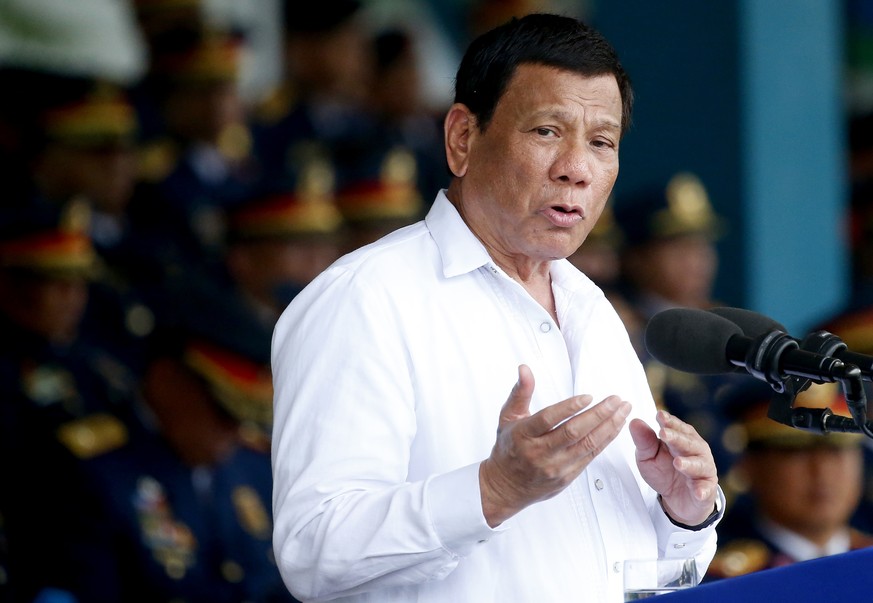 President Rodrigo Duterte gestures while addressing police force to mark the 117th Philippine National Police Service anniversary at Camp Crame in suburban Quezon city northeast of Manila, Philippines ...