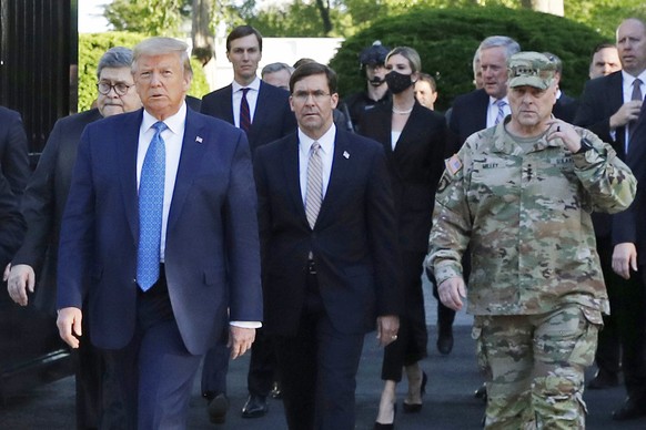 FILE - In this June 1, 2020 file photo, President Donald Trump departs the White House to visit outside St. John&#039;s Church, in Washington. Walking behind Trump from left are, Attorney General Will ...