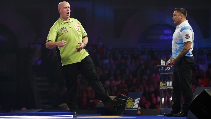 Michael van Gerwen of the Netherlands, left, celebrates taking the first set against Britain&#039;s Gerwyn Price on day eleven of the World Darts Championship at Alexandra Palace, London, Wednesday, D ...