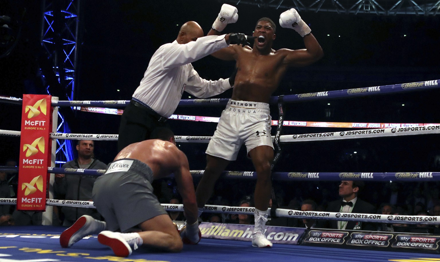 British boxer Anthony Joshua, right, reacts after flooring Ukrainian boxer Wladimir Klitschko during their fight for Joshua&#039;s IBF and the vacant WBA Super World and IBO heavyweight titles, at Wem ...