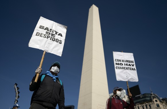 Activists demonstrate with signs that read in Spanish &quot;Stop the layoffs&quot; and &quot;With hunger, there is no quarantine&quot; at the Obelisk landmark in Buenos Aires, Argentina, Thursday, Apr ...