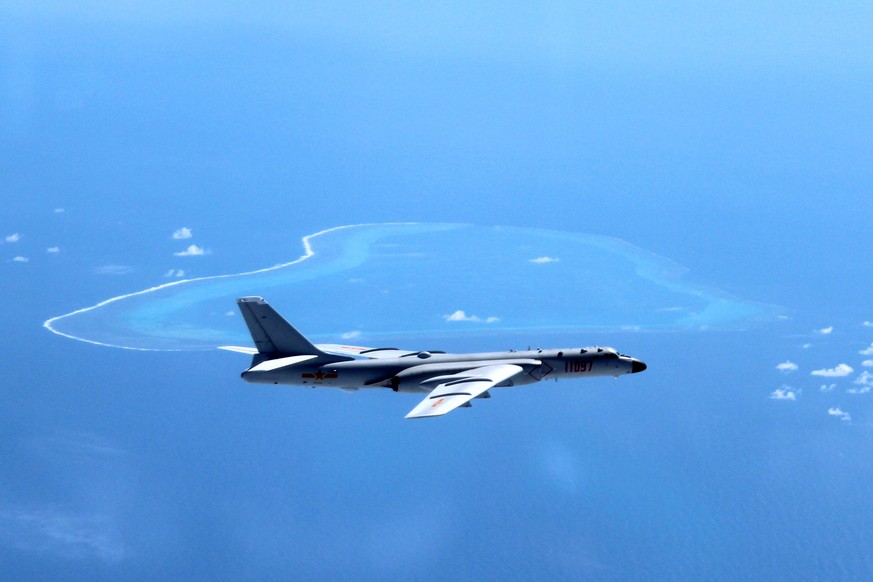 In this undated photo released by Xinhua News Agency, a Chinese H-6K bomber patrols the islands and reefs in the South China Sea. China is closing off a part of the South China Sea for military exerci ...