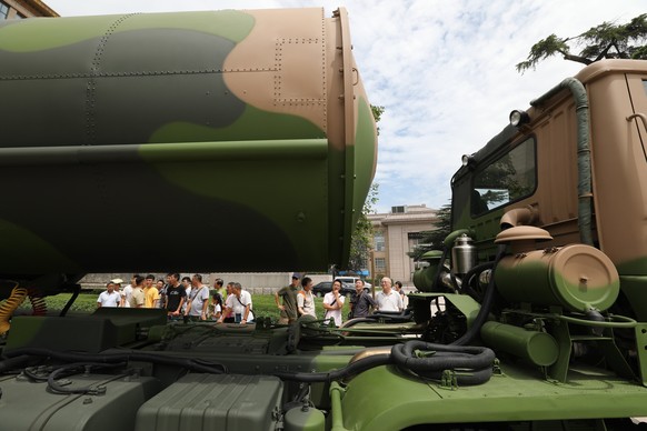 epa06111986 Visitors stand beside a DF-31 nuclear missile weapon system on display during an exhibition at the Military Museum to celebrate the People&#039;s Republic of China army 90th anniversary in ...
