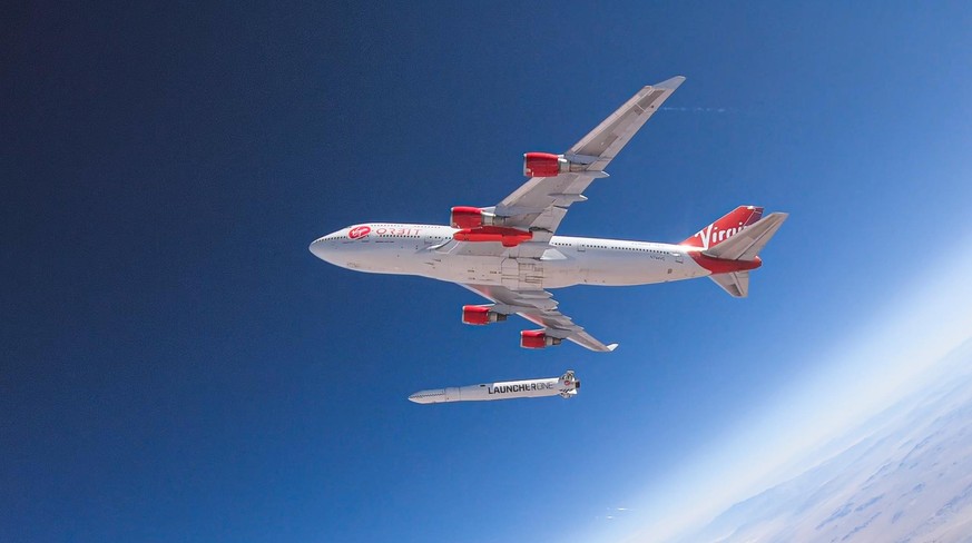epa08443994 A handout photo made available by Virgin Orbit on 25 May 2020 shows a test of a LauncherOne rocket being dropped from Cosmic Girl, a customized Boeing 747 aircraft that is used as the rock ...