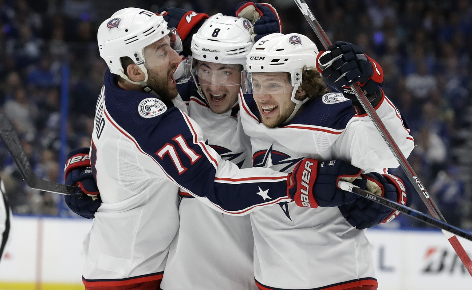 Columbus Blue Jackets defenseman Zach Werenski (8) celebrates his goal against the Tampa Bay Lightning with left wing Nick Foligno (71) and left wing Artemi Panarin (9) during the first period of Game ...