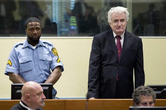 epa07450691 Former Bosnian Serb leader Radovan Karadzic (R) enters the court room of the Former Bosnian Serb leader Radovan Karadzic (R) enters the court room of the International Residual Mechanism f ...