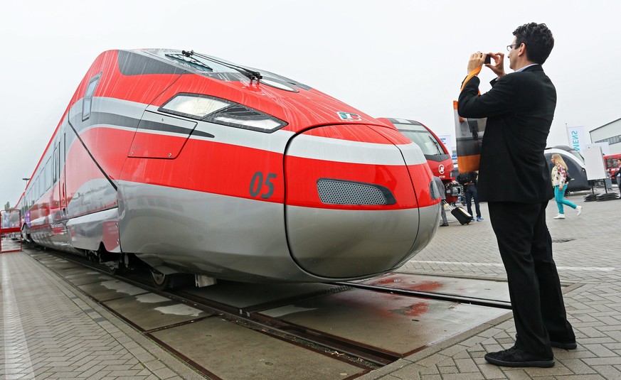 epa04418701 A visitor takes a photo of the Italian high-speed train &#039;Frecciarossa 1000&#039; at the InnoTrans International Trade Fair for Transport Technology in Berlin, Germany, 26 September 20 ...