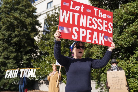 epa08108597 Laura Albinson with the Progressive Democrats of America participates at a small rally to urge action to &#039;impeach, remove, indict and jail&#039; President Trump outside the Hart Senat ...