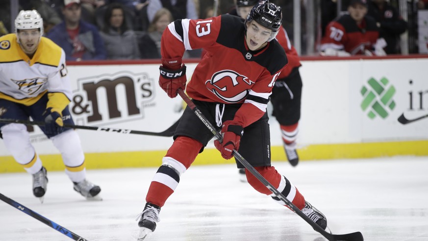 New Jersey Devils center Nico Hischier (13), of Switzerland, shoots against the Nashville Predators during the second period of an NHL hockey game, Thursday, Jan. 25, 2018, in Newark, N.J. (AP Photo/J ...