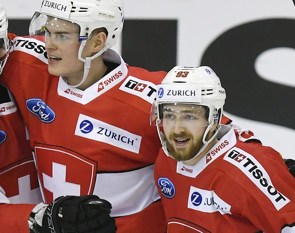 Swiss Philipp Kurashev, Gaetan Haas, Gregory Hofmann and Lino Martschini, celebrates after the first goal during the friendly Ice Hockey match between Switzerland and Latvia in Herisau, Switzerland, 0 ...