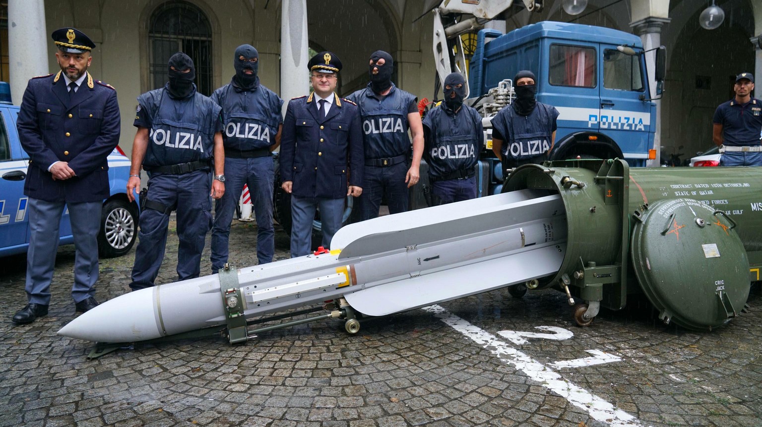 Police stand by a missile seized at an airport hangar near Pavia, northern Italy, following an investigation into Italians who took part in the Russian-backed insurgency in eastern Ukraine, in Turin,  ...