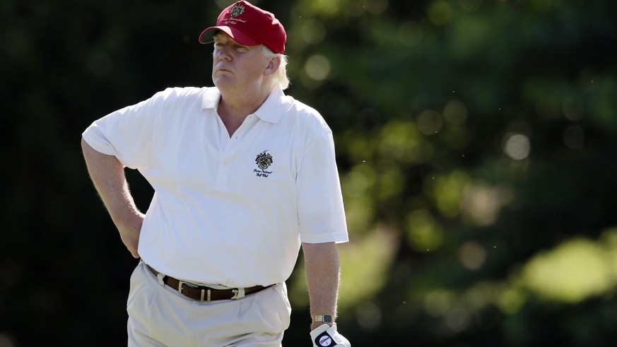 FILE - In this June 27, 2012, file photo, Donald Trump stands on the 14th fairway during a pro-am round of the AT&amp;T National golf tournament at Congressional Country Club in Bethesda, Md. Donald T ...