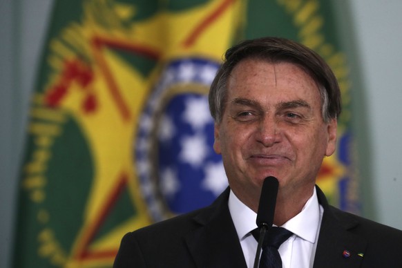 Brazil&#039;s President Jair Bolsonaro, smiles while speaking at a ceremony launching the housing program &quot;Green and Yellow House,&quot; at the Planalto presidential palace in Brasilia, Brazil, T ...