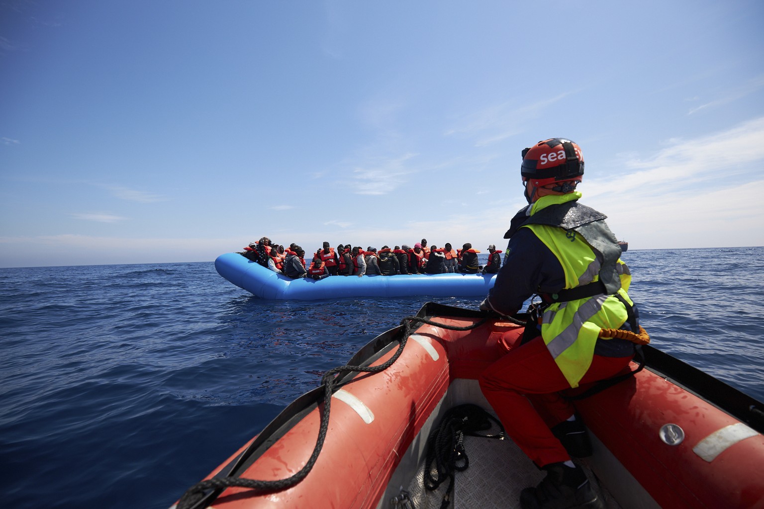 Migrants on a rubber dinghy are approached by Sea-Watch rescue ship&#039;s staffers in the waters off Libya Wednesday, April 3, 2019. The German humanitarian group Sea-Watch says the ship it operates  ...