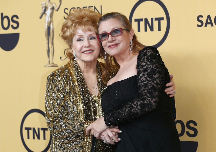 Actress Debbie Reynolds poses with her daughter actress Carrie Fisher backstage after accepting her Lifetime Achievement award at the 21st annual Screen Actors Guild Awards in Los Angeles, California  ...