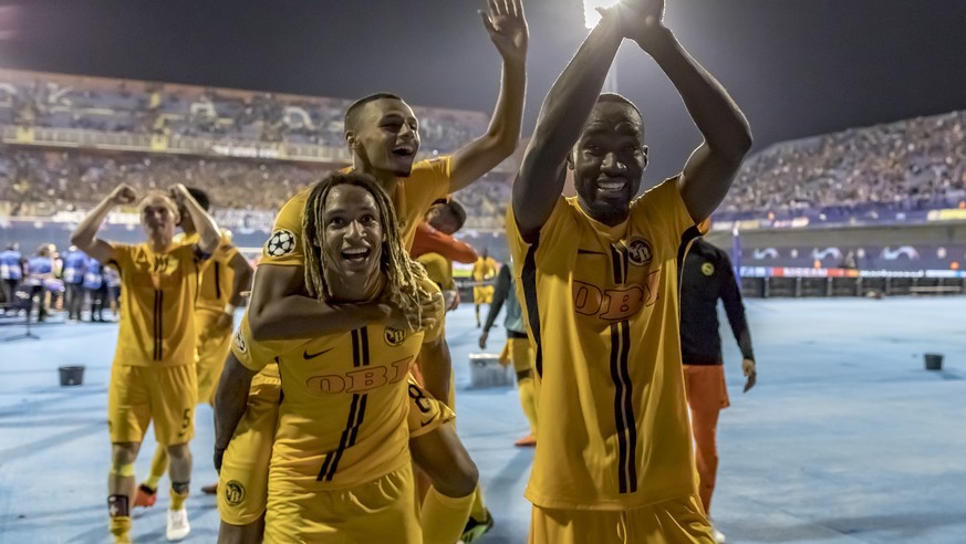 YBs Kevin Mbabu, Djibril Sow and Nicolas Moumi Ngamaleu, from left, celebrate after the UEFA Champions League football 2nd leg playoff match between GNK Dinamo Zagreb from Croatia and BSC Young Boys f ...