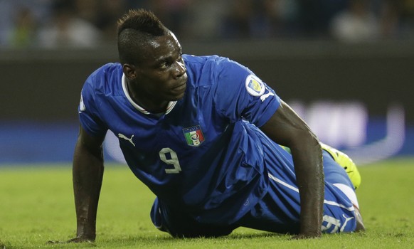 FILE - In this Oct. 15, 2013, file photo, Italy&#039;s Mario Balotelli lies on the pitch during a 2014 FIFA World Cup, Group B, qualification match between Italy and Armenia in Naples, Italy. Italy&#0 ...