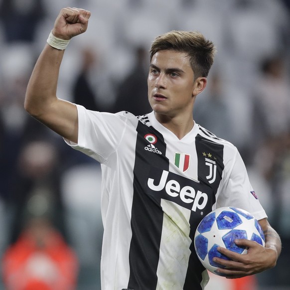Juventus forward Paulo Dybala holds the ball after scoring a hat trick at the end of the Champions League, group H soccer match between Juventus and Young Boys, at the Allianz stadium in Turin, Italy, ...