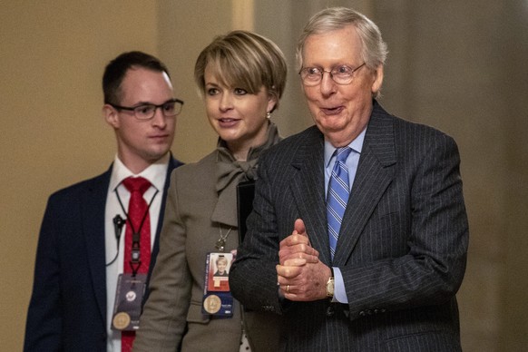Senate Majority Leader Mitch McConnell of Ky., right, walks to meet with Senate Republicans on Capitol Hill in Washington, Friday, Jan. 31, 2020, after the Senate voted to not allow witnesses in the i ...