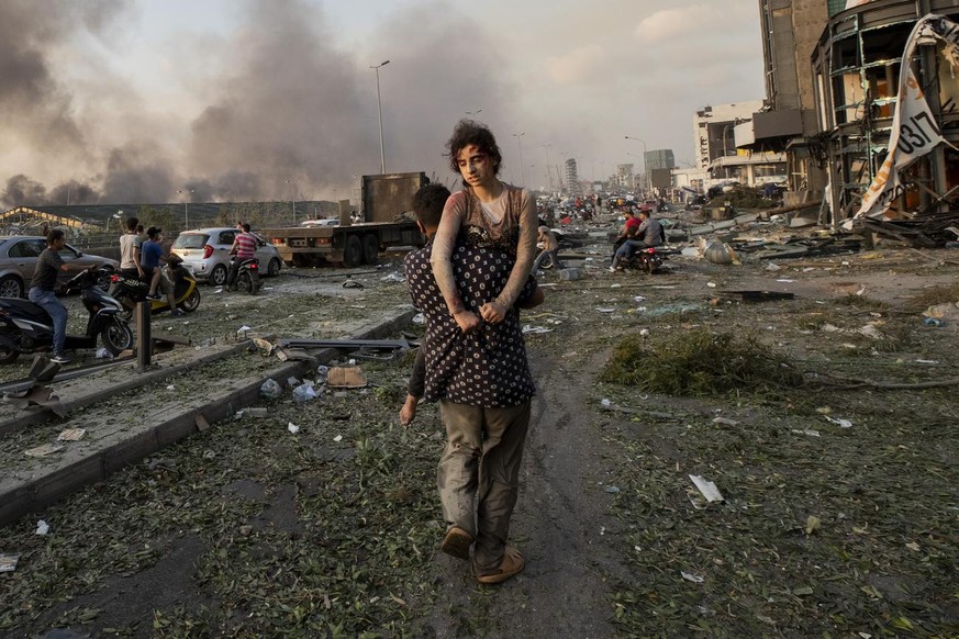 LEBANON AP PHOTO SYRIAN FAMILY
In this Aug. 4, 2020 photo, Hoda Kinno, 11, is evacuated by her uncle Mustafa, in the aftermath of a massive explosion at the port in Beirut, Lebanon. The Kinno family f ...