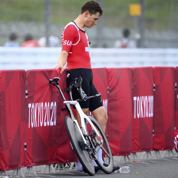 Fourth placed Stefan Kueng of Switzerland reacts after crossing the finish line during the men&#039;s cycling individual time trial at the 2020 Tokyo Summer Olympics at the Fuji International Speedway ...