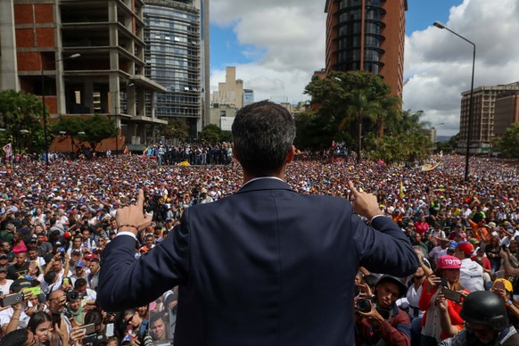 epa07313103 Juan Guaido, President of the Venezuelan Parliament, speaks to supporters as he announces that he assumes executive powers, in Caracas, Venezuela, 23 January 2019. Guaido declared himself  ...