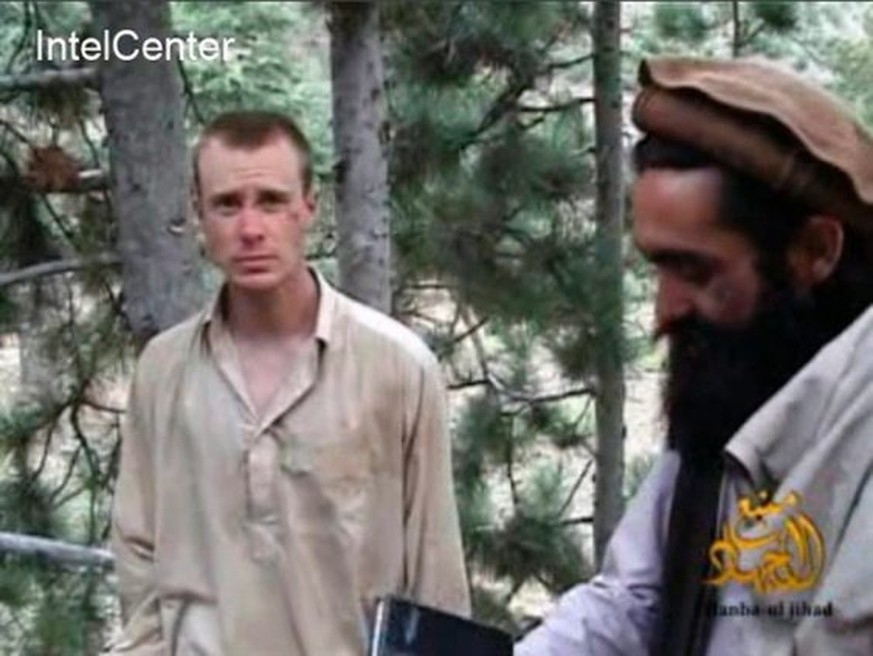epa04234511 A handout image released by IntelCenter showing captured US Army soldier Bowe Bergdahl (L) with a Taliban commander (R) in a video released by the Taliban in 2010. Sgt. Bowe Bergdahl was r ...