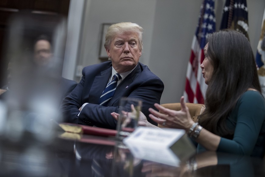 epa06431786 US President Donald J. Trump (L), listens as president and CEO of the Texas Public Policy Foundation Brooke Rollins (R) delivers remarks during a prison reform roundtable in the Roosevelt  ...