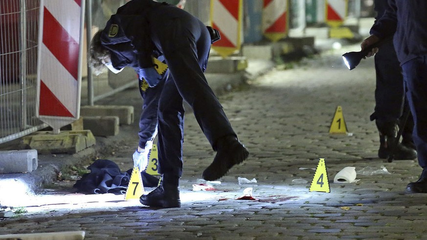 File---File picture taken Oct.5, 2020 shows criminal experts investigating a crime scene in Dresden, Germany. Two people died in a knife attack. The suspect that was arrested on Tuesday is known as a  ...