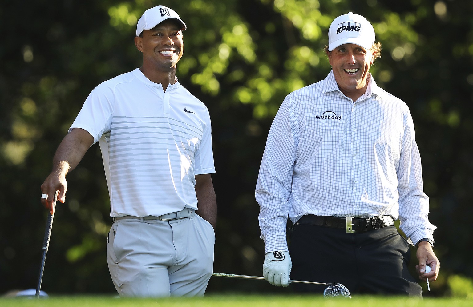 Tiger Woods, left, and Phil Mickelson share a laugh on the 11th tee box while playing a practice round for the Masters golf tournament at Augusta National Golf Club in Augusta, Ga., Tuesday, April 3,  ...