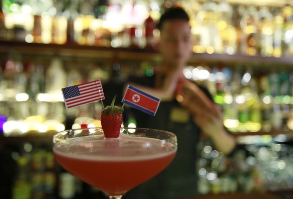 In this Feb. 22, 2019, photo, a glass of &quot;Rock It, Man&quot; cocktail, inspired from Trump-Kim Hanoi summit, is presented at a bar in Hanoi, Vietnam. The summit this week between Kim Jong Un and  ...