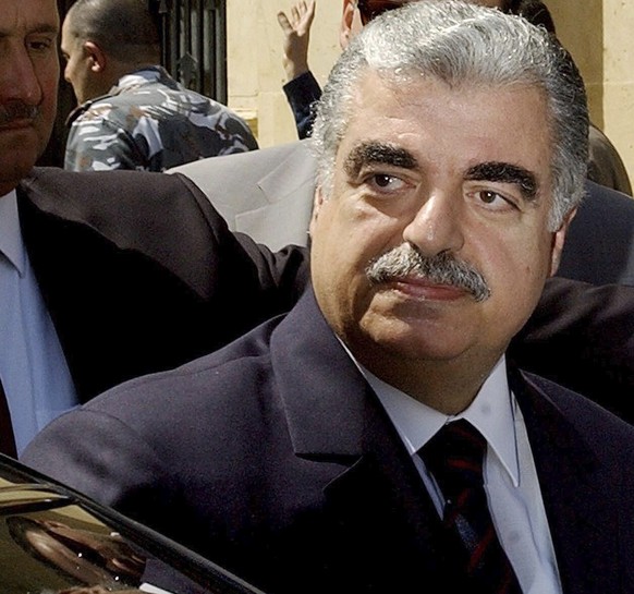 FILE - In this April 17, 2003 file photo Lebanese Prime Minister-designate Rafik Hariri leaves the Parliament building in Beirut, Lebanon. More than 15 years after the truck bomb assassination of form ...