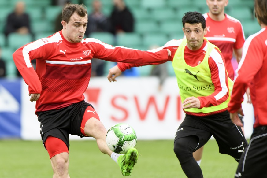 Swiss midfielder Blerim Dzemaili, right, fights for the ball against Swiss forward Xherdan Shaqiri, left, during a training session of the Switzerland soccer national team, at Juan-Antonio Samaranch s ...