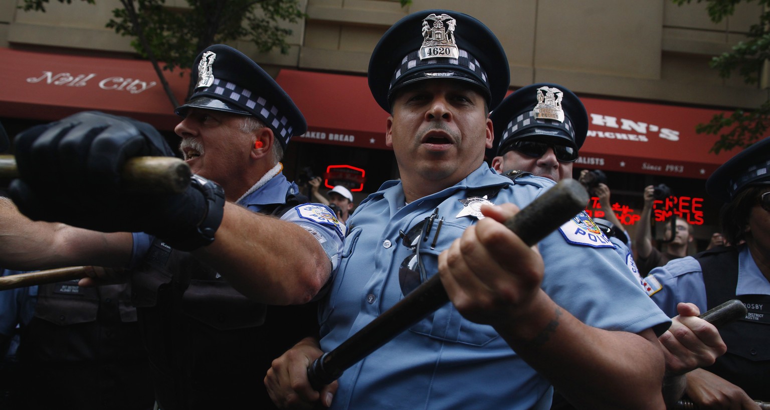 Police officers hold batons as demonstrators clash with the police during an anti-NATO protest march in Chicago May 20, 2012. Chicago police trying to keep the peace during the NATO summit may face th ...