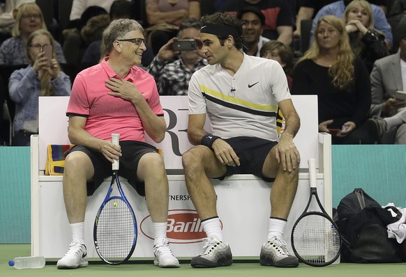 Bill Gates, left, smiles as he talks with partner Roger Federer, of Switzerland, as they play an exhibition tennis match against Jack Sock and Savannah Guthrie in San Jose, Calif., Monday, March 5, 20 ...