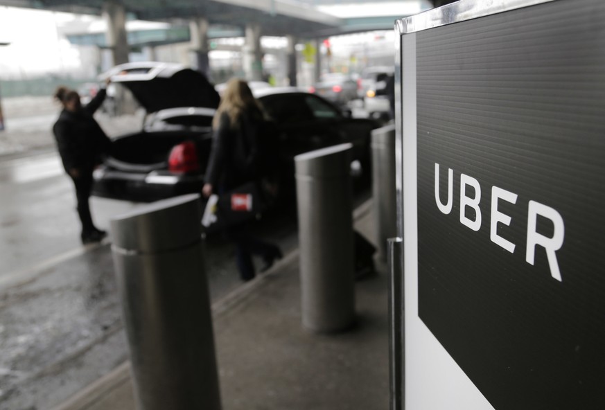 FILE - In this March 15, 2017, file photo, a sign marks a pick up point for the Uber car service at LaGuardia Airport in New York. Startup SURE says it has partnered with underwriter Chubb to launch a ...