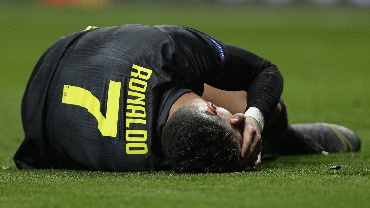 Juventus forward Cristiano Ronaldo lies on the ground during the Champions League round of 16 first leg soccer match between Atletico Madrid and Juventus at Wanda Metropolitano stadium in Madrid, Wedn ...
