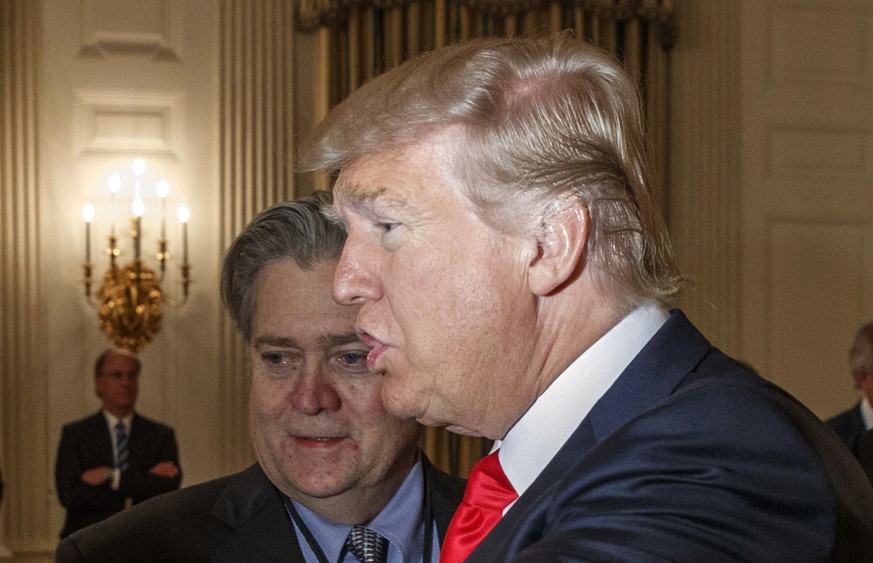 FILE - In this Feb. 3, 2017 file photo, President Donald Trump and White House chief strategist Steve Bannon are seen in the State Dining Room of the White House in Washington. In a pair of interviews ...