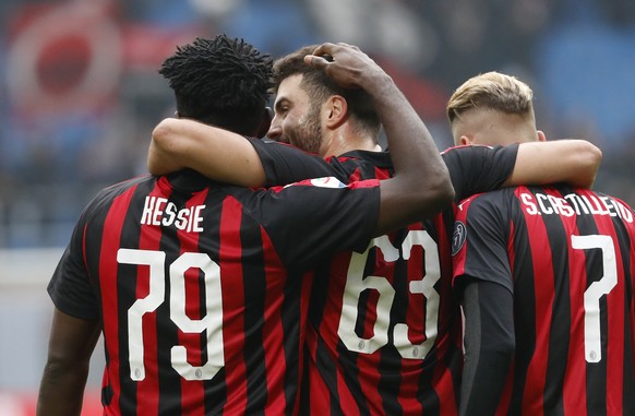 AC Milan&#039;s Franck Kessie, left, celebrates with his teammates Patrick Cutrone, center, and Samuel Castillejo at the end off the Serie A soccer match between AC Milan and Parma at the San Siro Sta ...