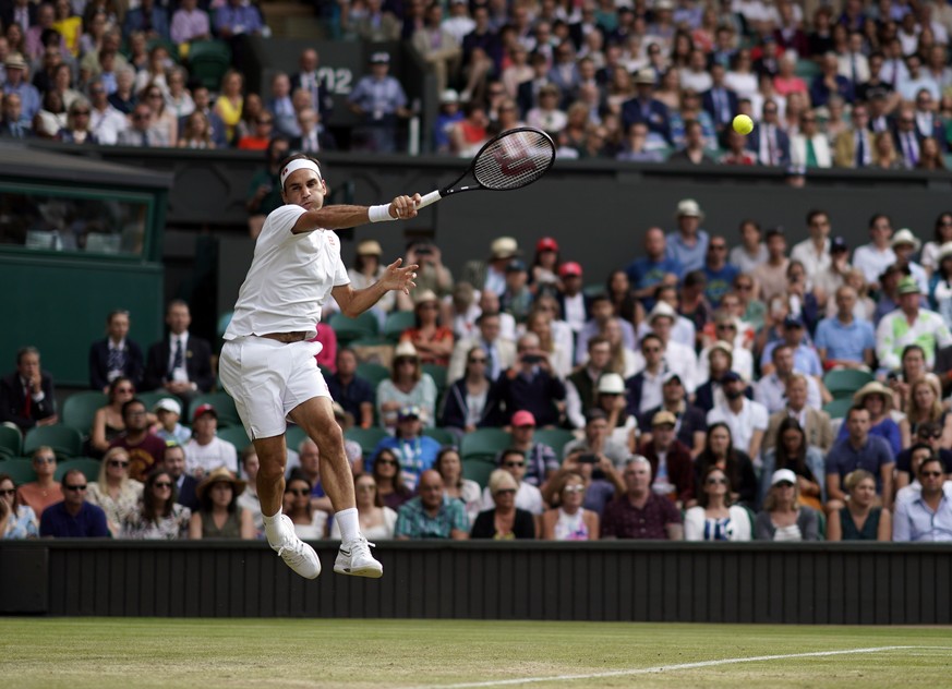 epa07699496 Roger Federer of Switzerland plays Lucas Pouille of France in their third round match during the Wimbledon Championships at the All England Lawn Tennis Club, in London, Britain, 06 July 20 ...