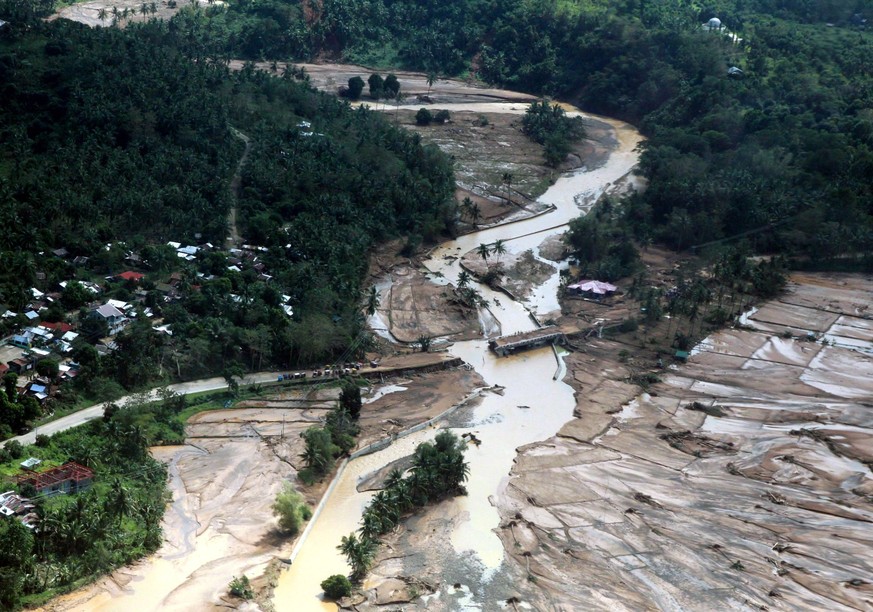 epa06397011 A handout photo made available by the Presidential Photographers Division (PPD) shows an aerial image of a damaged bridge in the town of Naval, Biliran island, Philippines, 18 December 201 ...
