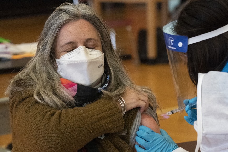 Teacher Lisa Egan is vaccinated with the Moderna coronavirus vaccine at a clinic organized by New York City&#039;s Department of Health, Monday, Jan. 11, 2021. &quot;I feel so great, so lucky,&quot; s ...