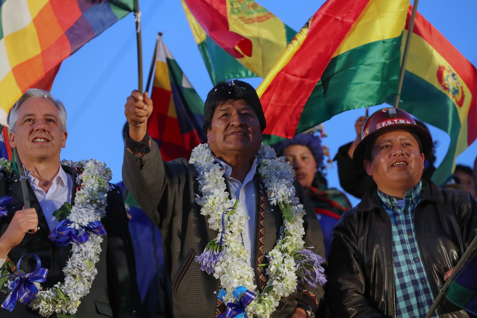 epa07957209 President of Bolivia Evo Morales (C) and Vice President Alvaro Garcia Linera (L) participate in an event in El Alto, Bolivia, 28 October 2019. Morales called on supporters to defend the he ...