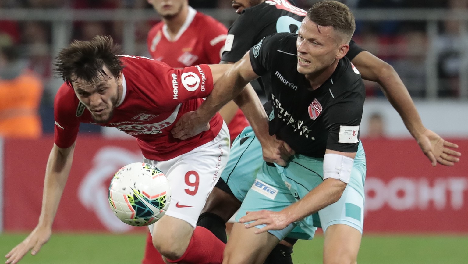 epa07775093 Reziuan Mirzov (L) of Spartak Moscow in action against Stefan Glarner (R) of FC Thun during UEFA Europa League third qualifying round, second leg, soccer match between Spartak Moscow and F ...
