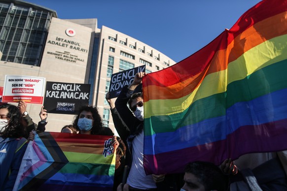 epa08984770 Students of Bogazici University hold LGBTQI+ rainbow flags and shout slogans in front of the Istanbul Courthouse, in Istanbul, Turkey, 03 February 2021. They protested in support of friend ...