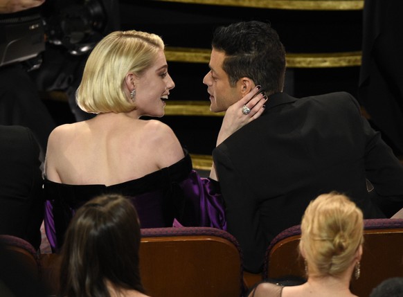 Lucy Boynton, left, congratulates Rami Malek, winner of the award for best performance by an actor in a leading role for &quot;Bohemian Rhapsody&quot; at the Oscars on Sunday, Feb. 24, 2019, at the Do ...
