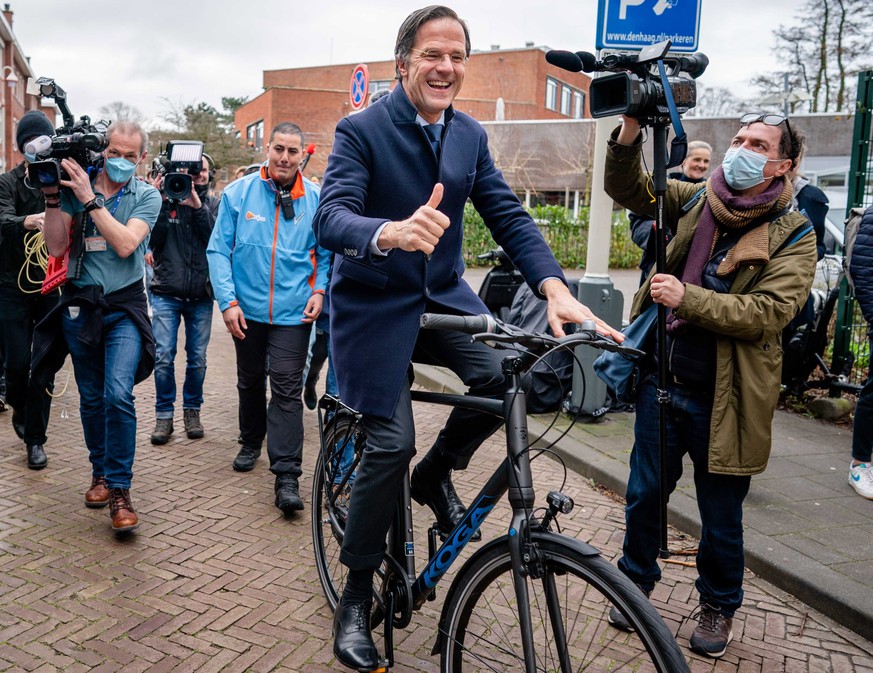 epa09079727 VVD party leader Mark Rutte leaves on his bicycle at primary school De Woltersschool, after he has cast his vote in the House of Representatives elections, in The Hague, the Netherlands, 1 ...
