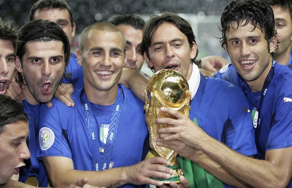 Italy&#039;s, from left, Vincenzo Iaquinta, Fabio Cannavaro, Filippo Inzaghi and Fabio Grosso celebrate with the World Cup trophy after the final of the soccer World Cup between Italy and France in th ...