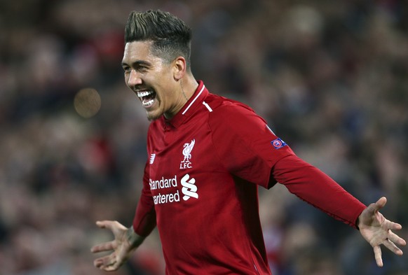 Liverpool&#039;s Roberto Firmino celebrates after scoring his side&#039;s second goal during the Champions League quarterfinal, first leg, soccer match between Liverpool and FC Porto at Anfield Stadiu ...