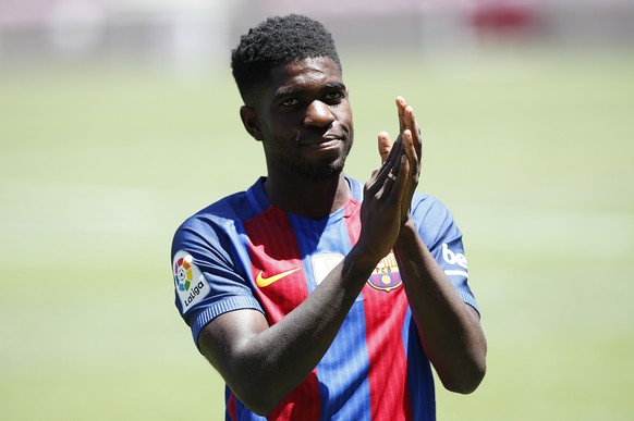 FC Barcelona&#039;s new signing Samuel Umtiti applauds during his official presentation at the Camp Nou stadium in Barcelona, Spain, Friday, July 15, 2016. Barcelona has signed France defender Samuel  ...